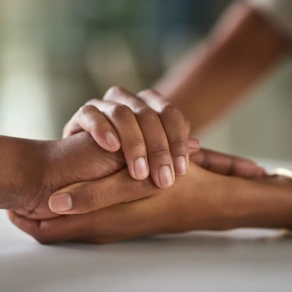 offering support by holding a hand
